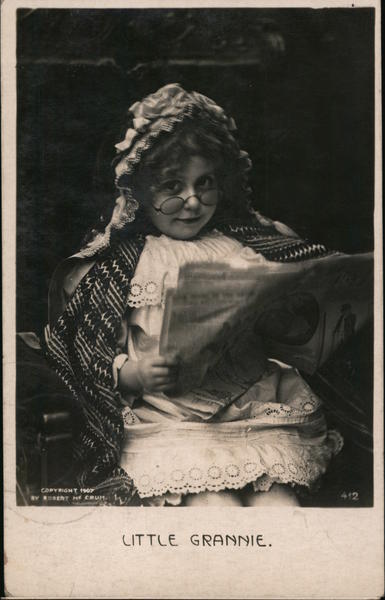 Little Grannie No. 412 Little girl dressed as granny reading paper