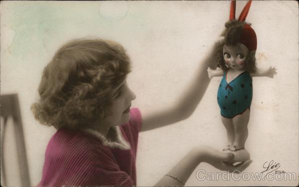 Girl with Kewpie Doll in Bathing Suit and Cap Dolls