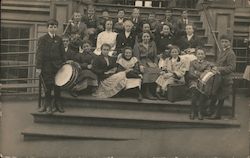 Group School photo. Some students have band instruments. Postcard