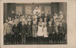 Group of children posing for a picture with their teacher Postcard