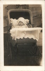 Baby in wicker baby buggy Postcard