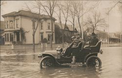 Flood - people in car sitting in floodwater in a neighborhood Postcard