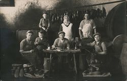 Group of shoemakers, coblers posing at a table with their work Postcard