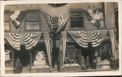 St. Patrick's Day Display Windows. U.S. Flag and banners on display on building. Postcard