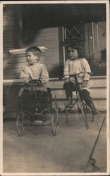 Two children tricycle and toy cart Postcard