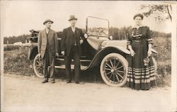 Two Men and a Woman Standing in Front of Car Postcard