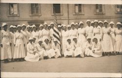 Nurses group photo around American Flag in courtyard Postcard