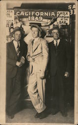 Three men posing at bar - California 1849, Bull horns, Check your guns at the bar sign Postcard