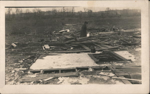 A Woman Walking Through a Destroyed Property Disasters