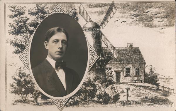 Man's portrait, with a windmill and building in the background.