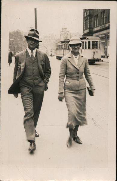 1935 Man and woman on sidewalk, wearing hats and suits Germany