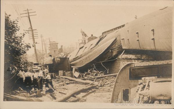 Men Standing Around Destruction and an Overturned Train