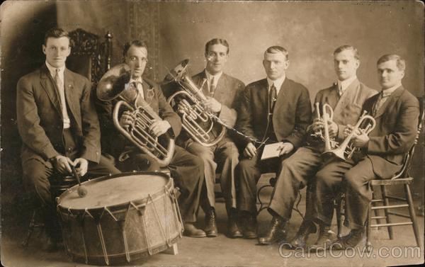 Brass Band with one drummer, two tubas, two trumpets, and conductor
