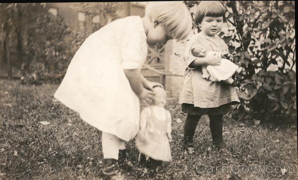 Little girls outdoors with their dolls