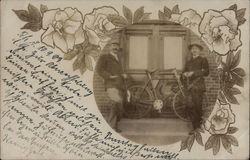 Two men posing near a bicycle Postcard