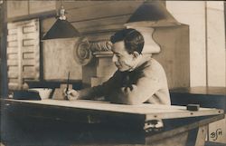 Man drawing while sitting at desk Postcard