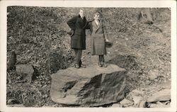 Two Men in Coats Standing on a Giant Boulder Postcard