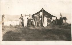 People standing outside near cars in a tent Postcard