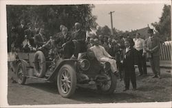 Group of men in and around a car Postcard