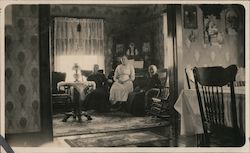 Three women in a sitting room Postcard