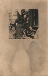 Person posing on the steps of a house Postcard