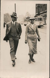 1935 Man and woman on sidewalk, wearing hats and suits Postcard