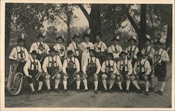 Musical Group wearing lederhosen and hats Postcard