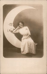 Woman sitting on Paper Moon Postcard