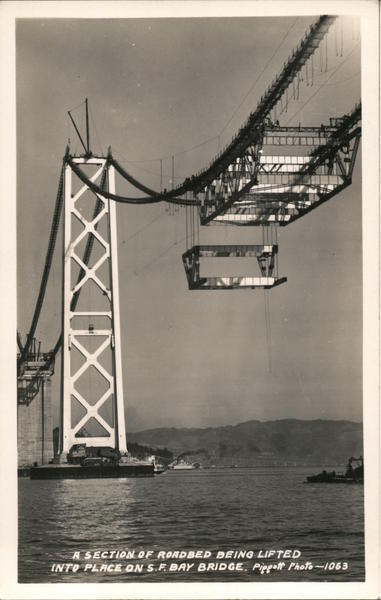 A section of roadbed being lifted into place on S.F. bay bridge Oakland California