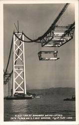 A section of roadbed being lifted into place on S.F. bay bridge Oakland, CA Piggott Photo Postcard Postcard Postcard