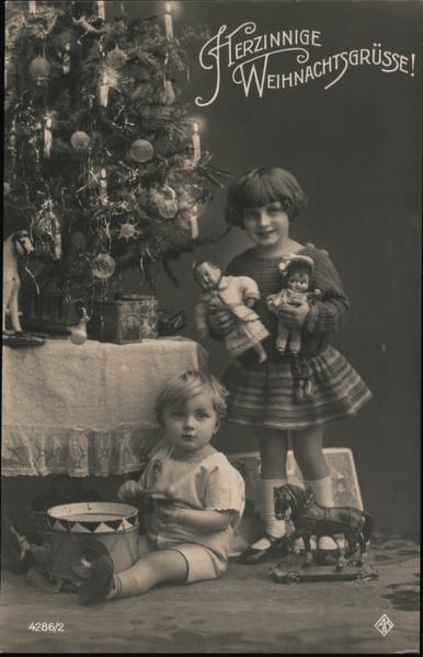 Children and a Christmas tree. Christmas Greetings in German