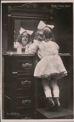 Her First Bow - Young girl looking at herself in a dresser mirror Children Postcard Postcard Postcard