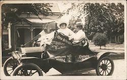 Couple Driving Pennant Decorated Car Postcard
