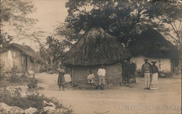 A Family Standing Outside of a Grass Hut Kingston Jamaica