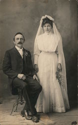 A Groom Sitting Next to his Standing Bride Postcard