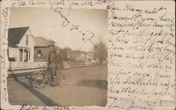 Two men with bicycles stopped in street Petaluma California