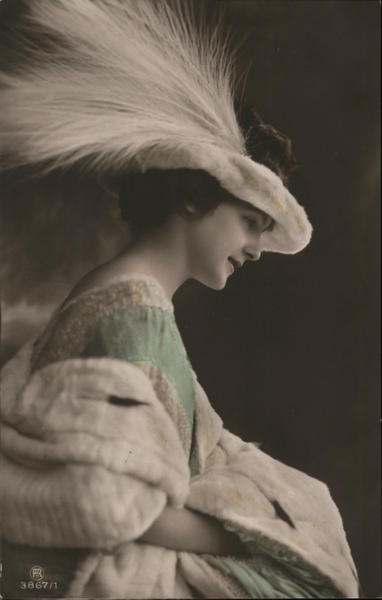 Woman in green dress with white feathered hat Women