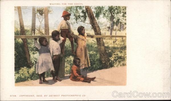 Waiting for the circus. Black children waiting at side of road.