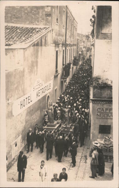 Parade, men carrying two statues, Hotel Metropole Taormina Italy
