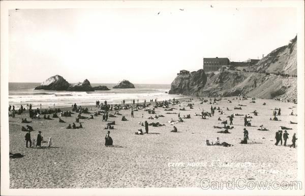 People on the beach with view of Cliff House and Seal Rock San Francisco California