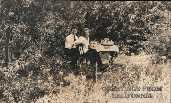 Couple eating a meal at table in Golden Gate Park. Greetings from California San Francisco