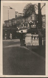 Trolleys across from the Clarion Hotel, man posing at bridge column Original Photograph