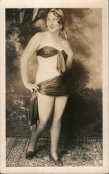 Woman with minimal clothing standing on a rug posing Postcard