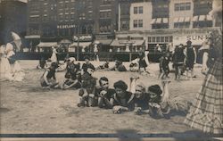 Beach near boardwalk. Beach goers in swimsuits, parasols Postcard