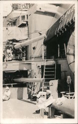 Sailors in dress whites on deck of ship, artillery gun stations Postcard
