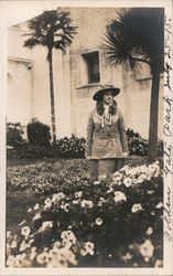 Golden Gate Park. Woman standing by flower bed Postcard