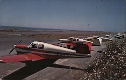 Airport at Shelter Cove. Several planes parked on runway. Postcard