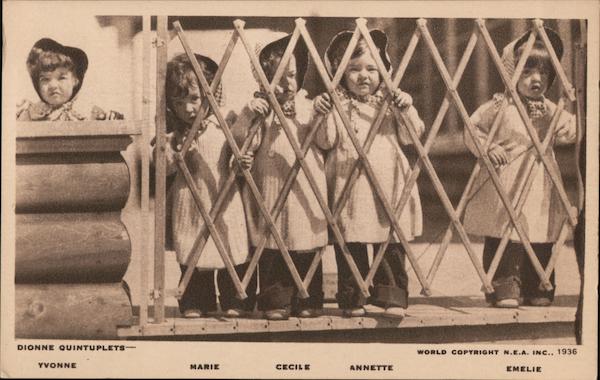 Dionne quintuplets standing at gate. Yvonne, Marie, Cecil, Annette, Emelie