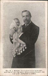 Rev. W. J. Myers (Senior Deputation Secretary) with one of the 1100 Babies Rescued from Poverty Postcard