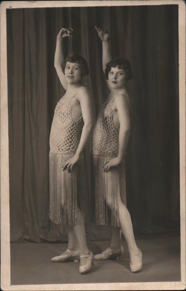 Two women dancers posing, in show costumes Dancing